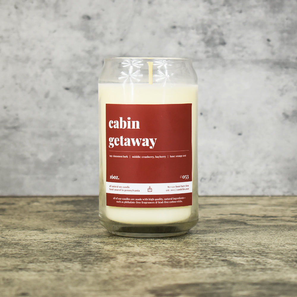 Cabin Getaway scent soy wax candle in can shaped glass vessel with tapered top and rich reddish brown label