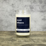 Sweet Tobacco scent soy wax candle in can shaped glass vessel with tapered top and deep charcoal colored label